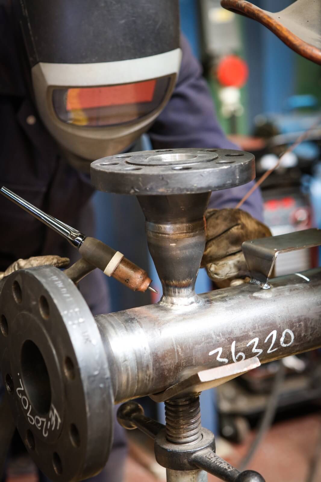 Welder working on a pipe assembly