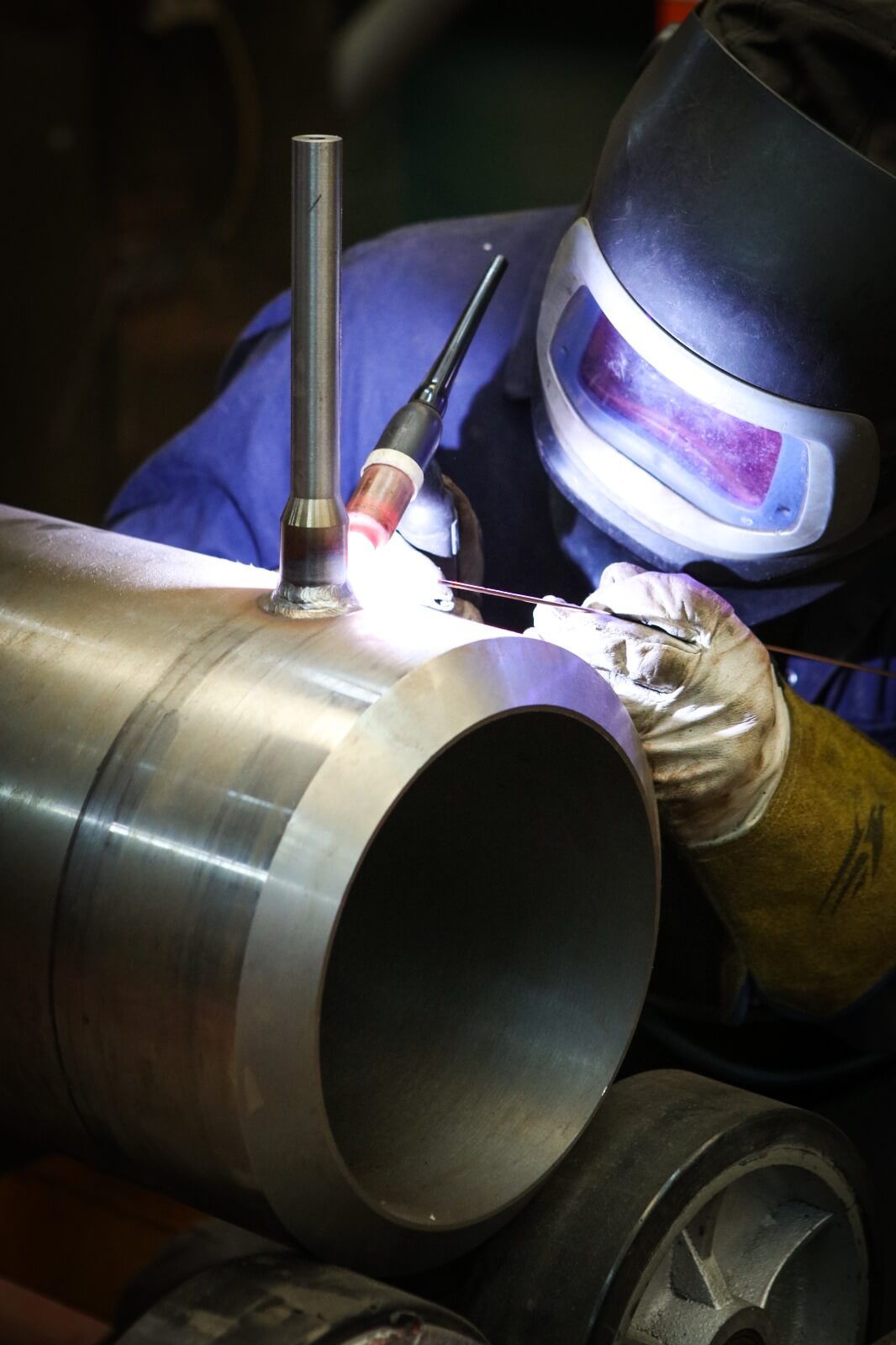 Welder fabricating a large pipe